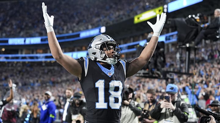 Jan 10, 2026; Charlotte, NC, USA;  Carolina Panthers wide receiver Jalen Coker (18) celebrates his score with fans during the second half of the NFC Wild Card Round game between the Carolina Panthers and the Los Angeles Rams at Bank of America Stadium. Mandatory Credit: Jim Dedmon-Imagn Images
