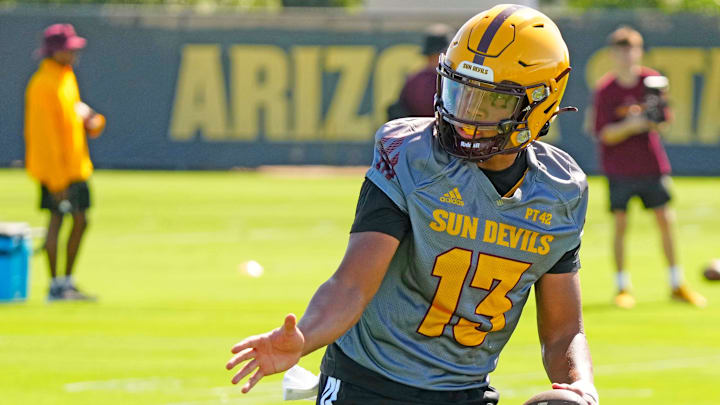 Arizona State quarterback Cameron Dyer (13) fakes a hand-off during the first day of fall practice in Tempe, Ariz. on July 30, 2025. Arizona State quarterback Cameron Dyer (13) fakes a hand-off during the first day of fall practice in Tempe, Ariz. on July 30, 2025.