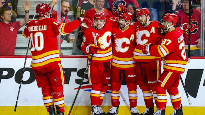 Apr 11, 2025; Calgary, Alberta, CAN; Calgary Flames center Nazem Kadri (91) celebrates his goal with teammates against the Minnesota Wild during the second period at Scotiabank Saddledome. Mandatory Credit: Sergei Belski-Imagn Images