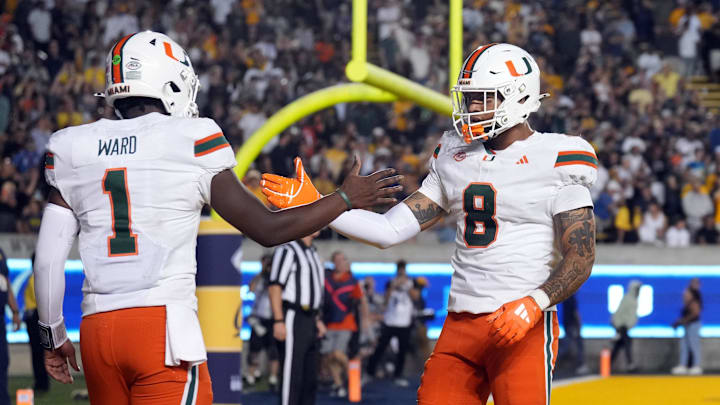 Oct 5, 2024; Berkeley, California, USA; Miami Hurricanes quarterback Cam Ward (1) is congratulated by tight end Elijah Arroyo (8) after scoring a touchdown against the California Golden Bears during the fourth quarter at California Memorial Stadium. Mandatory Credit: Darren Yamashita-Imagn Images Oct 5, 2024; Berkeley, California, USA; Miami Hurricanes quarterback Cam Ward (1) is congratulated by tight end Elijah Arroyo (8) after scoring a touchdown against the California Golden Bears during the fourth quarter at California Memorial Stadium. Mandatory Credit: Darren Yamashita-Imagn Images