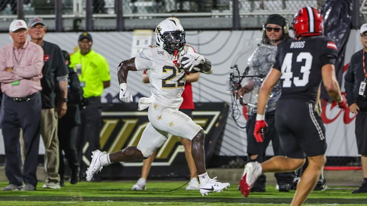Aug 28, 2025; Orlando, Florida, USA; UCF Knights running back Myles Montgomery (22) runs the ball during the second quarter against the Jacksonville State Gamecocks at Acrisure Bounce House. Mandatory Credit: Mike Watters-Imagn Images