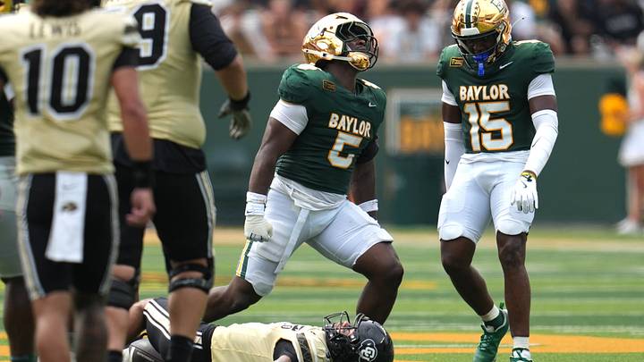Sep 26, 2026; Waco, Texas, USA;  Baylor Bears linebacker Travion Barnes (5) celebrates after tackling Colorado Buffaloes wide receiver DeAndre Moore Jr. (3) for a short gain during the first half at McLane Stadium.  Mandatory Credit: Chris Jones-Imagn Images
