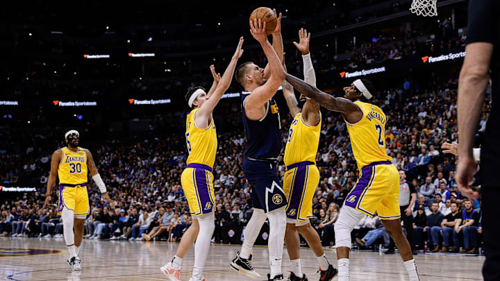 Mar 14, 2025; Denver, Colorado, USA; Denver Nuggets center Nikola Jokic (15) drives to the basket against Los Angeles Lakers forward Markieff Morris (88) and guard Austin Reaves (15) and forward Jarred Vanderbilt (2) in the second quarter at Ball Arena. Mandatory Credit: Isaiah J. Downing-Imagn Images Mar 14, 2025; Denver, Colorado, USA; Denver Nuggets center Nikola Jokic (15) drives to the basket against Los Angeles Lakers forward Markieff Morris (88) and guard Austin Reaves (15) and forward Jarred Vanderbilt (2) in the second quarter at Ball Arena. Mandatory Credit: Isaiah J. Downing-Imagn Images