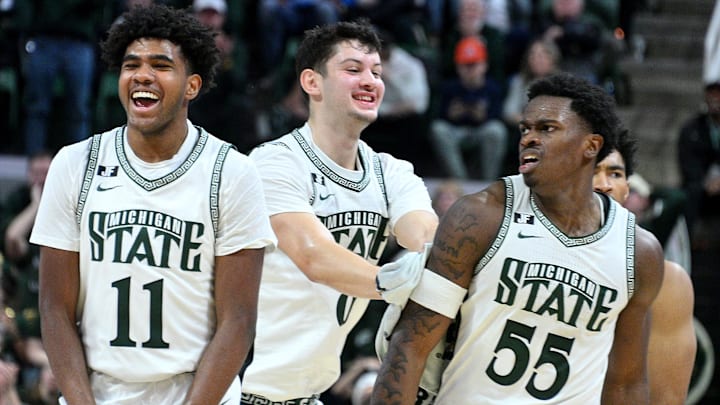 Dec 21, 2024; East Lansing, Michigan, USA;  Michigan State Spartans including guard Jase Richardson (11)  forward Frankie Fidler (8) and forward Coen Carr (55) celebrate a big play by Carr against the Florida Atlantic Owls during the second halfat Jack Breslin Student Events Center. Mandatory Credit: Dale Young-Imagn Images