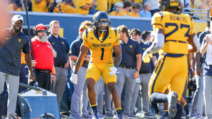 Aug 30, 2025; Morgantown, West Virginia, USA; West Virginia Mountaineers running back Jahiem White (1) celebrates with West Virginia Mountaineers running back Cyncir Bowers (23) after his touchdown run during the fourth quarter against the Robert Morris Colonials at Milan Puskar Stadium. Mandatory Credit: Ben Queen-Imagn Images