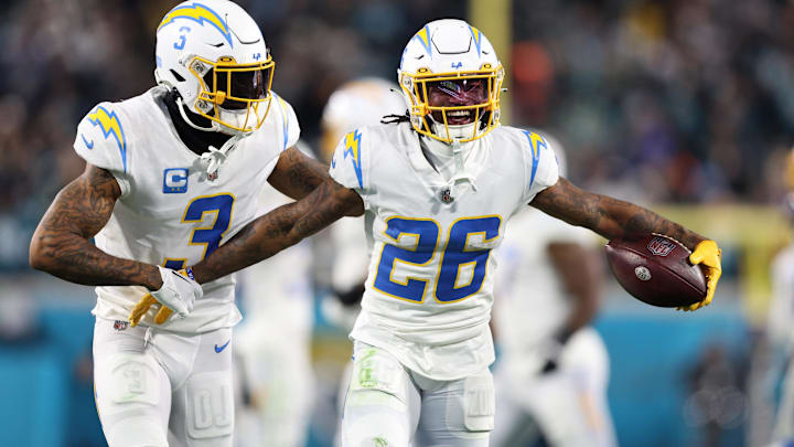 Jan 14, 2023; Jacksonville, Florida, USA; Los Angeles Chargers cornerback Asante Samuel Jr. (26) celebrates with safety Derwin James Jr. (3) after an interception during the second quarter of a wild card game against the Jacksonville Jaguars at TIAA Bank Field. Mandatory Credit: Nathan Ray Seebeck-Imagn Images