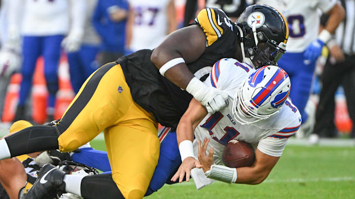 Aug 17, 2024; Pittsburgh, Pennsylvania, USA;  Pittsburgh Steelers defensive tackle Keeanu Benton (95) sacks Buffalo Bills quarterback Mitchell Trubisky (11) during the first quarter at Acrisure Stadium. Mandatory Credit: Barry Reeger-Imagn Images