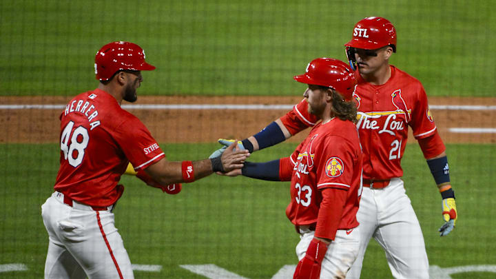 May 23, 2025; St. Louis, Missouri, USA;  St. Louis Cardinals designated hitter Ivan Herrera (48) right fielder Lars Nootbaar (21) and left fielder Brendan Donovan (33) celebrate after they scored on a three run triple by third baseman Nolan Arenado (not pictured) during the sixth inning against the Arizona Diamondbacks at Busch Stadium. Mandatory Credit: Jeff Curry-Imagn Images