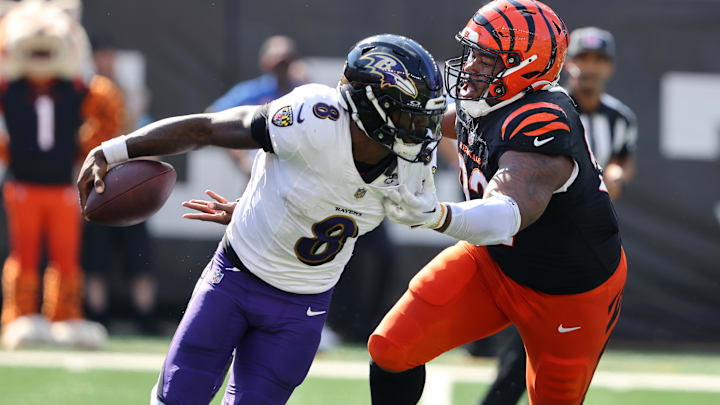 Baltimore Ravens quarterback Lamar Jackson (8) escapes the pressure from Cincinnati Bengals defensive tackle B.J. Hill (92) during the first half at Paycor Stadium on Oct. 6, 2024