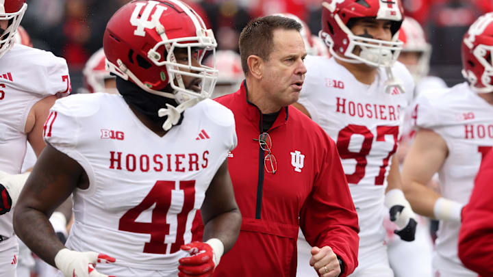 Indiana Hoosiers head coach Curt Cignetti runs with his team before the game against the Ohio State Buckeyes at Ohio Stadium. Indiana Hoosiers head coach Curt Cignetti runs with his team before the game against the Ohio State Buckeyes at Ohio Stadium.