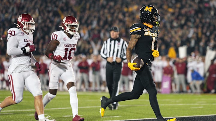 Nov 9, 2024; Columbia, Missouri, USA; Missouri Tigers wide receiver Theo Wease Jr. (1) scores a touchdown against Oklahoma Sooners defensive lineman Ethan Downs (40) and linebacker Kip Lewis (10) during the second half at Faurot Field at Memorial Stadium. Mandatory Credit: Jay Biggerstaff-Imagn Images