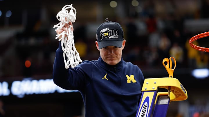 Mar 29, 2026; Chicago, IL, USA; Michigan Wolverines head coach Dusty May cuts the net after defeating the Tennessee Volunteers in an Elite Eight game of the Midwest Regional of the men's 2026 NCAA Tournament at United Center. Mandatory Credit: Kamil Krzaczynski-Imagn Images