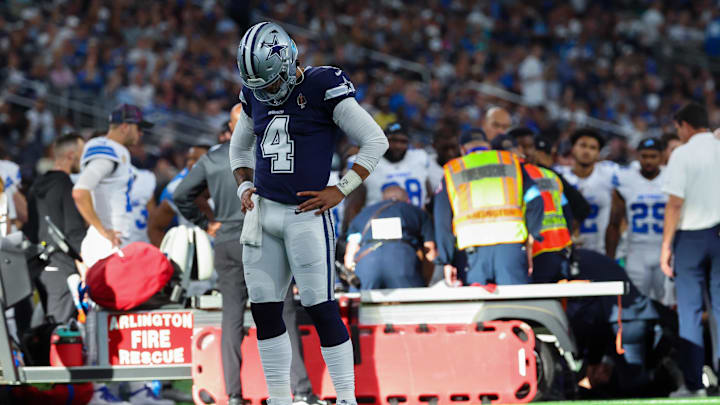 Oct 13, 2024; Arlington, Texas, USA;  Dallas Cowboys quarterback Dak Prescott (4) says a prayer for Detroit Lions injured defensive end Aidan Hutchinson (97) during the second half at AT&T Stadium. Mandatory Credit: Kevin Jairaj-Imagn Images