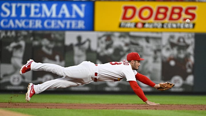Jul 15, 2022; St. Louis, Missouri, USA;  St. Louis Cardinals third baseman Nolan Arenado (28) dives but is unable to field a one run single hit by Cincinnati Reds designated hitter Joey Votto (not pictured) during the third inning at Busch Stadium. Mandatory Credit: Jeff Curry-Imagn Images
