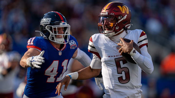 Washington Commanders quarterback Jayden Daniels (5) runs with the ball while being chased by New York Giants linebacker Micah McFadden (41) during a game between the New York Giants and the Washington Commanders at MetLife Stadium in East Rutherford on Sunday, Nov. 3, 2024.