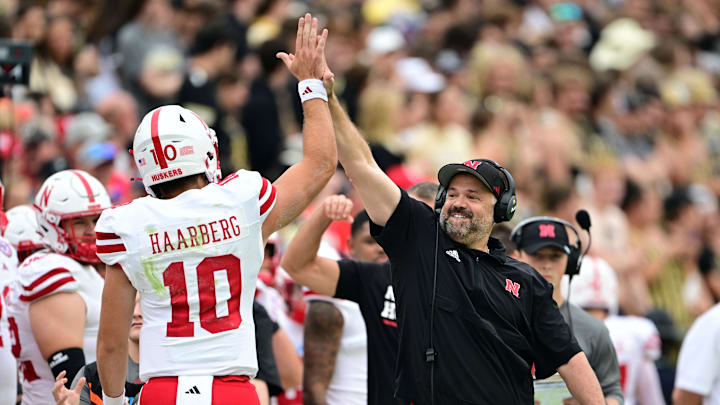 Sep 28, 2024; West Lafayette, Indiana, USA; Nebraska Cornhuskers head coach Matt Rhule high fives quarterback Heinrich Haarberg (10) during the first quarter against the Purdue Boilermakers at Ross-Ade Stadium. Mandatory Credit: Marc Lebryk-Imagn Images