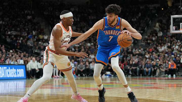 Jan 24, 2024; San Antonio, Texas, USA; Oklahoma City Thunder forward Chet Holmgren (7) dribbles against San Antonio Spurs guard Malaki Branham (22) in the second half at Frost Bank Center.