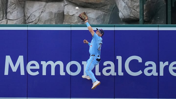 Aug 14, 2024; Anaheim, California, USA; Toronto Blue Jays left fielder Daulton Varsho (25) attempts to catch a fly ball double by Los Angeles Angels left fielder Taylor Ward (not pictured) in the second inning at Angel Stadium. Mandatory Credit: Kirby Lee-Imagn Images