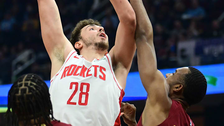 Mar 26, 2023; Cleveland, Ohio, USA; Houston Rockets center Alperen Sengun (28) shoots over the defense of Cleveland Cavaliers forward Evan Mobley (4) during the first half at Rocket Mortgage FieldHouse. Mandatory Credit: Ken Blaze-Imagn Images