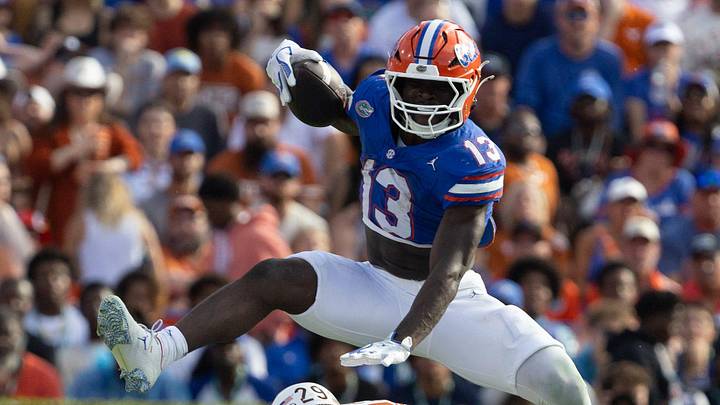 Florida running back Jadan Baugh leaps over Texas defensive back Graceson Littleton Florida running back Jadan Baugh leaps over Texas defensive back Graceson Littleton