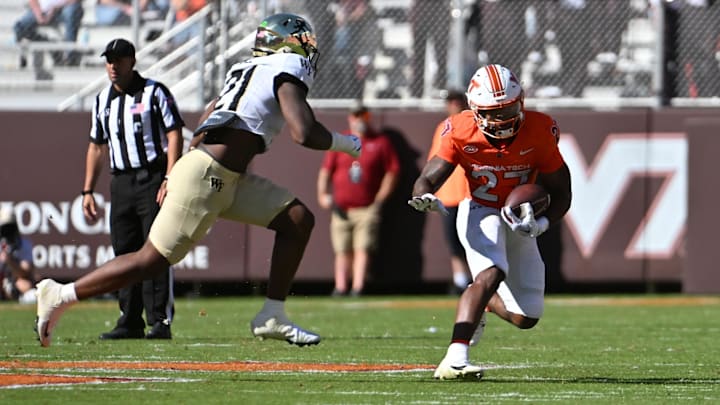 Oct 4, 2025; Blacksburg, Va.; Virginia Tech running back Marcellous Hawkins (27) runs with the ball against Wake Forest linebacker Aiden Hall (21).