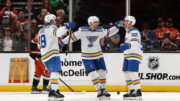 Mar 8, 2026; Anaheim, California, USA;  St. Louis Blues left wing Jonathan Drouin (92) celebrates with center Robert Thomas (18) and left wing Dylan Holloway (middle) after scoring a goal during the second period against the Anaheim Ducks at Honda Center. Mandatory Credit: Kiyoshi Mio-Imagn Images