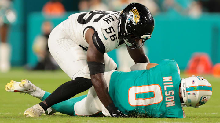 Aug 23, 2025; Miami Gardens, Florida, USA; Jacksonville Jaguars linebacker Yasir Abdullah (56) sacks Miami Dolphins quarterback Zach Wilson (0) during the third quarter at Hard Rock Stadium. Mandatory Credit: Sam Navarro-Imagn Images