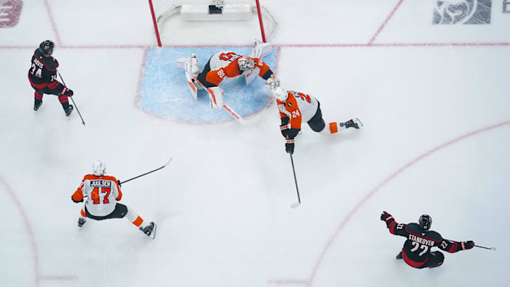 May 2, 2026; Raleigh, North Carolina, USA; Carolina Hurricanes center Logan Stankoven (22) celebrates his goal past Philadelphia Flyers goaltender Dan Vladar (80) and defenseman Nick Seeler (24) during the second period at Lenovo Center. 