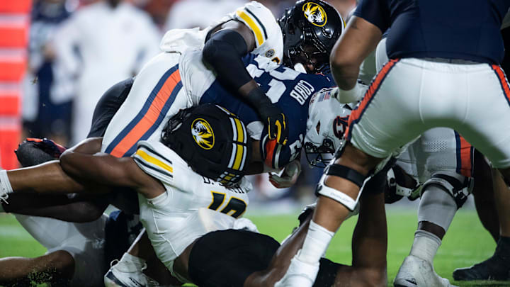 Missouri Tigers defensive end Darris Smith (19) is injured as he tackles Auburn Tigers running back Jeremiah Cobb (23) as Auburn Tigers take on Missouri Tigers at Jordan-Hare Stadium in Auburn, Ala. on Saturday, Oct. 18, 2025. Missouri Tigers lead Auburn Tigers 10-7 at halftime.