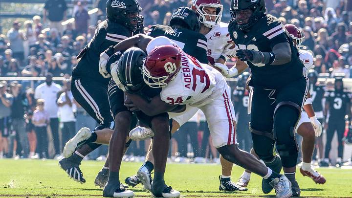 Oklahoma defensive end Adepoju Adebawore sacks Mississippi State quarterback Kamario Taylor early in Saturday's 23-15 win over the Bulldogs. Oklahoma defensive end Adepoju Adebawore sacks Mississippi State quarterback Kamario Taylor early in Saturday's 23-15 win over the Bulldogs.