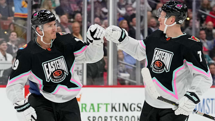 Feb 4, 2023; Sunrise, Florida, USA; Atlantic Division forward Matthew Tkachuk (19) of the Florida Panthers fist bumps Atlantic Division forward Brady Tkachuk (71) of the Ottawa Senators during the second period of a semifinal game during the 2023 NHL All-Star Game at FLA Live Arena. Mandatory Credit: Jasen Vinlove-Imagn Images