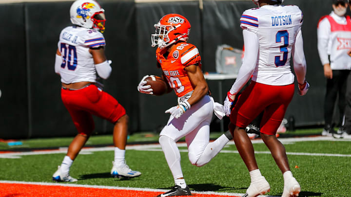 Oct 14, 2023; Stillwater, Oklahoma, USA; Oklahoma State's Brennan Presley (80) scores a touchdown in the first quarter against the Kansas Jayhawks at Boone Pickens Stadium. Mandatory Credit: Nathan J. Fish-Imagn Images Oct 14, 2023; Stillwater, Oklahoma, USA; Oklahoma State's Brennan Presley (80) scores a touchdown in the first quarter against the Kansas Jayhawks at Boone Pickens Stadium. Mandatory Credit: Nathan J. Fish-Imagn Images