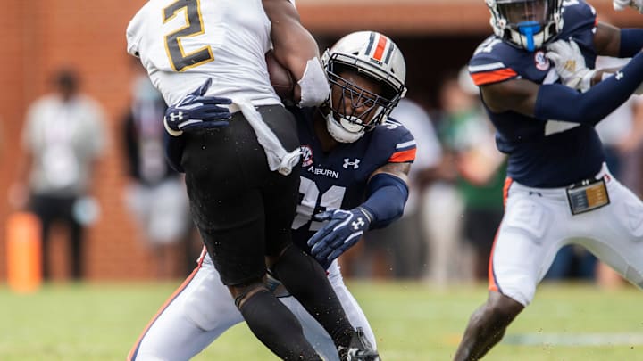 Alabama State Hornets running back Jacory Merritt (2) is taken down by Auburn Tigers linebacker Chandler Wooten (31) at Jordan-Hare Stadium in Auburn, Ala., on Saturday, Sept. 11, 2021. Auburn Tigers leads Alabama State Hornets 20-0 at halftime.