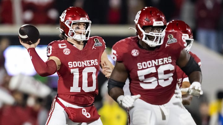 Oklahoma Sooners quarterback John Mateer (10) and offensive lineman Michael Fasusi (56) against the Alabama Crimson Tide during the CFP National Playoff First Round at Gaylord Family—Oklahoma Memorial Stadium.  Fasusi returns as a starter on the Sooners' offensive line in 2026.