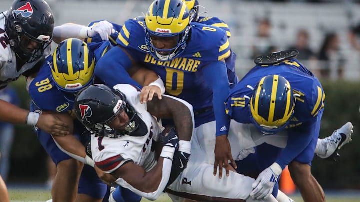 Delaware's Nick Karika (98) Q'yaeir Price (0) and K.T. Seay tackle Penn running back Malachi Hosley in the second quarter at Delaware Stadium, Saturday, Sept. 21, 2024.