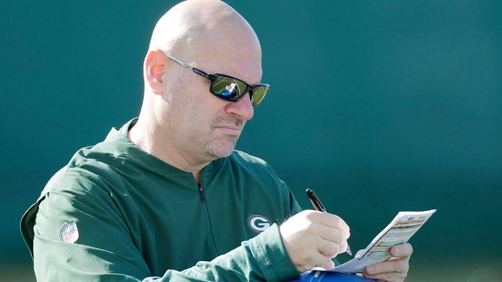 Green Bay Packers defensive coordinator Mike Pettine takes notes during practice at Ray Nitschke Field 