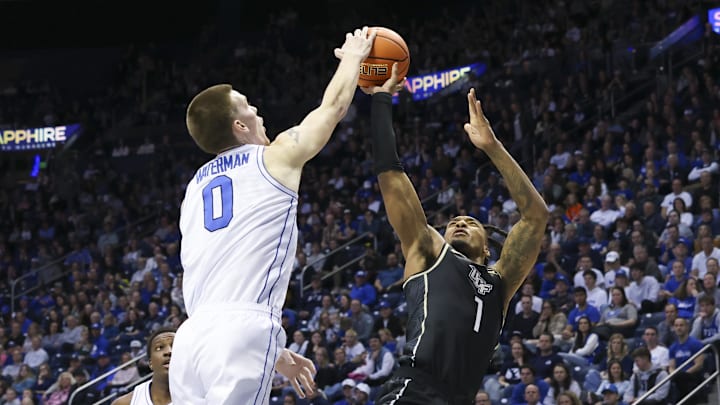 Feb 13, 2024; Provo, Utah, USA; Brigham Young Cougars forward Noah Waterman (0) blocks the shot of Antwann Jones (1).