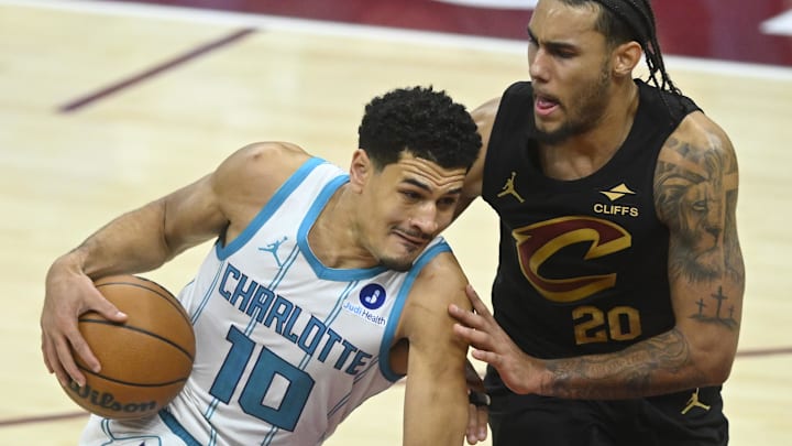 Dec 14, 2025; Cleveland, Ohio, USA; Charlotte Hornets guard Josh Green (10) dribbles beside Cleveland Cavaliers guard Jaylon Tyson (20) in the fourth quarter at Rocket Arena. Mandatory Credit: David Richard-Imagn Images