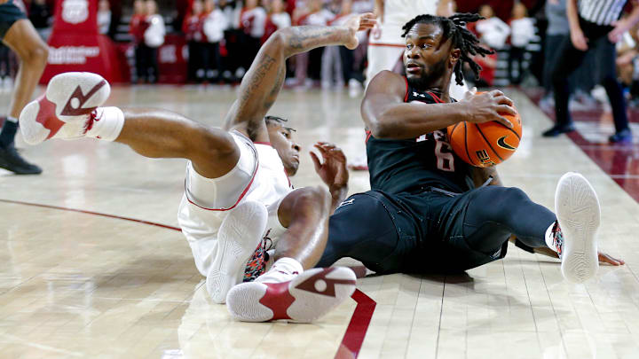Texas Tech guard Joe Toussaint (6) and Oklahoma forward Jalon Moore (14) fall to the ground fighting
