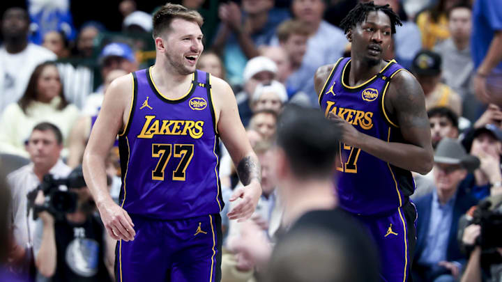 Los Angeles Lakers guard Luka Doncic (77) laughs with forward Dorian Finney-Smith (17) against the Dallas Mavericks during the second half at American Airlines Center.