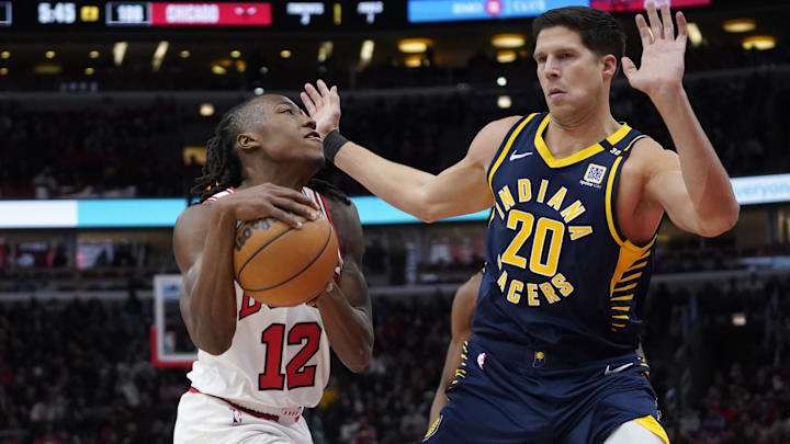 Mar 27, 2024; Chicago, Illinois, USA; Indiana Pacers forward Doug McDermott (20) defends Chicago Bulls guard Ayo Dosunmu (12) during the second half at United Center. Mandatory Credit: David Banks-Imagn Images