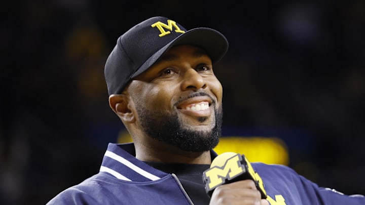 Jan 19, 2025; Ann Arbor, Michigan, USA; Michigan Wolverines head football coach Sherrone Moore fires up the crowd in overtime of the basketball game against the Northwestern Wildcats at Crisler Center. Mandatory Credit: Rick Osentoski-Imagn Images Jan 19, 2025; Ann Arbor, Michigan, USA; Michigan Wolverines head football coach Sherrone Moore fires up the crowd in overtime of the basketball game against the Northwestern Wildcats at Crisler Center. Mandatory Credit: Rick Osentoski-Imagn Images