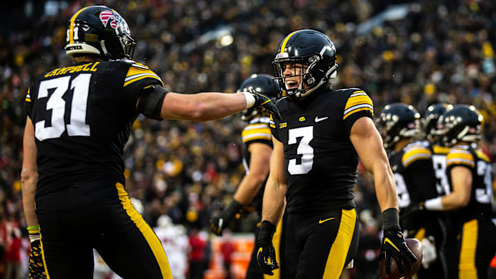 Iowa defensive back Cooper DeJean (3) celebrates with linebacker Jack Campbell after returning an intercepted pass for a touchdown during a NCAA Big Ten Conference football game against Wisconsin, Saturday, Nov. 12, 2022, at Kinnick Stadium in Iowa City, Iowa. Iowa defensive back Cooper DeJean (3) celebrates with linebacker Jack Campbell after returning an intercepted pass for a touchdown during a NCAA Big Ten Conference football game against Wisconsin, Saturday, Nov. 12, 2022, at Kinnick Stadium in Iowa City, Iowa.