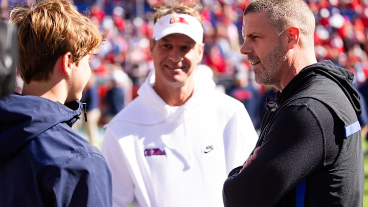 Florida Gators head coach Billy Napier talks with Mississippi Rebels head coach Lane Kiffin before the start of the game at Ben Hill Griffin Stadium in Gainesville, FL on Saturday, November 23, 2024. [Doug Engle/Gainesville Sun]