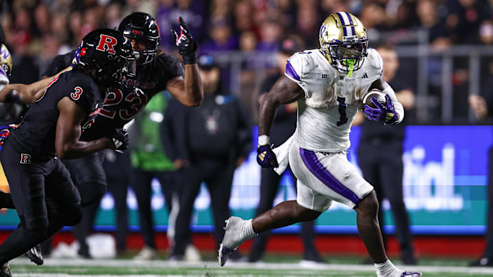 Sep 27, 2024; Piscataway, New Jersey, USA; Washington Huskies running back Jonah Coleman (1) runs the ball as Rutgers Scarlet Knights defensive back Bo Mascoe (3) pursues during the second half at SHI Stadium. Mandatory Credit: Vincent Carchietta-Imagn Images