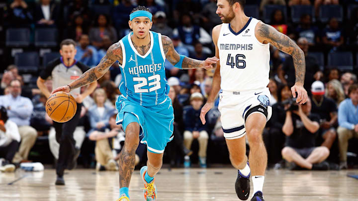 Oct 10, 2024; Memphis, Tennessee, USA; Charlotte Hornets guard Tre Mann (23) dribbles as Memphis Grizzlies guard John Konchar (46) defends during the first half at FedExForum. Mandatory Credit: Petre Thomas-Imagn Images
