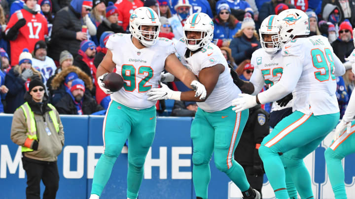 Defensive tackle Zach Sieler (92) celebrates his touchdown against the Buffalo Bills during the second half of the NFL wild card game at Highmark Stadium in the 2022 season. Defensive tackle Zach Sieler (92) celebrates his touchdown against the Buffalo Bills during the second half of the NFL wild card game at Highmark Stadium in the 2022 season.