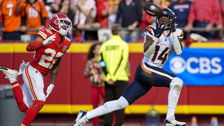 Nov 10, 2024; Kansas City, Missouri, USA; Denver Broncos wide receiver Courtland Sutton (14) catches a touchdown pass against Kansas City Chiefs cornerback Trent McDuffie (22) during the first half at GEHA Field at Arrowhead Stadium. Mandatory Credit: Jay Biggerstaff-Imagn Images