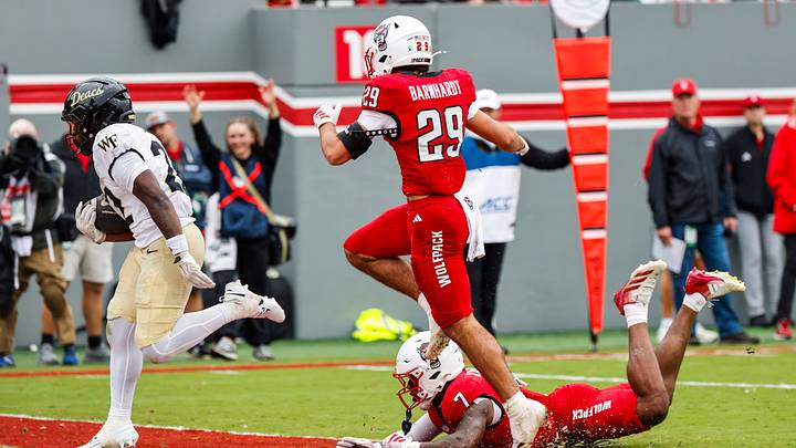 Oct 10, 2026; Raleigh, North Carolina, USA; Wake Forest Demon Deacons running back Deuce Lawrence (22) makes a touchdown past NC State Wolfpack safety Brody Barnhardt (29) and cornerback Brian Nelson II (7) during the second half of the game at Carter-Finley Stadium. Mandatory Credit: Jaylynn Nash-Imagn Images Oct 10, 2026; Raleigh, North Carolina, USA; Wake Forest Demon Deacons running back Deuce Lawrence (22) makes a touchdown past NC State Wolfpack safety Brody Barnhardt (29) and cornerback Brian Nelson II (7) during the second half of the game at Carter-Finley Stadium. Mandatory Credit: Jaylynn Nash-Imagn Images