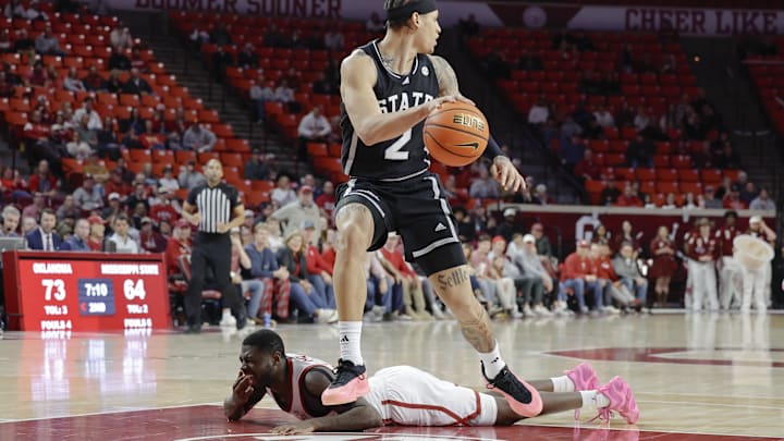 Oklahoma Sooners guard Duke Miles lies on the floor after fighting for a loose ball, which Mississippi State Bulldogs guard Riley Kugel, grabs on Feb. 22, 2025.